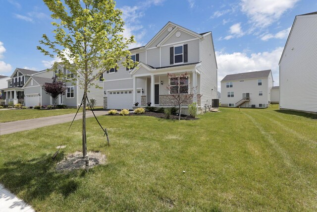 211 Whitetail Trl, Johnstown, OH 43031 - view of front facade featuring driveway, a porch, a front lawn, an attached garage, and a residential view