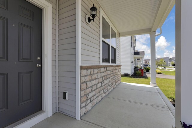 211 Whitetail Trl, Johnstown, OH 43031 - view of exterior entry featuring covered porch, stone siding, and a residential view