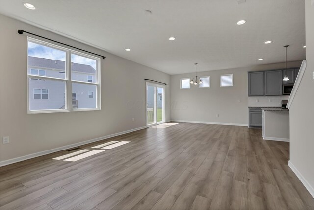211 Whitetail Trl, Johnstown, OH 43031 - unfurnished living room featuring wood finished floors, baseboards, and recessed lighting