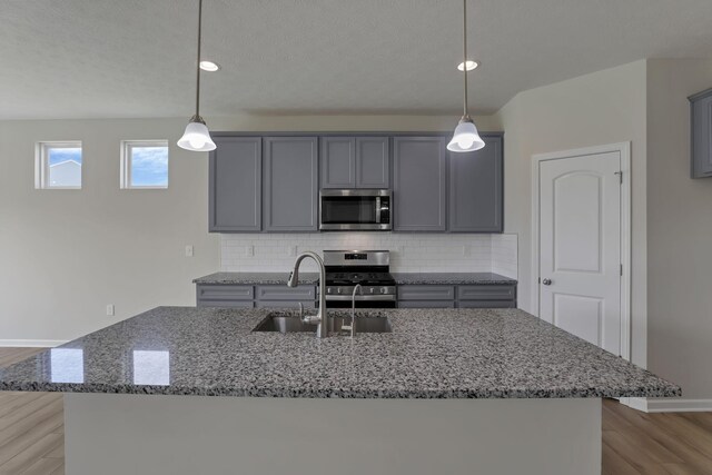 211 Whitetail Trl, Johnstown, OH 43031 - kitchen with appliances with stainless steel finishes, gray cabinets, a sink, stone counters, and recessed lighting