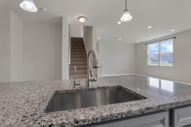 211 Whitetail Trl, Johnstown, OH 43031 - kitchen with a sink, light stone countertops, decorative light fixtures, and recessed lighting
