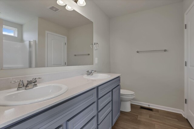 211 Whitetail Trl, Johnstown, OH 43031 - bathroom with toilet, double vanity, wood finished floors, baseboards, and an enclosed shower