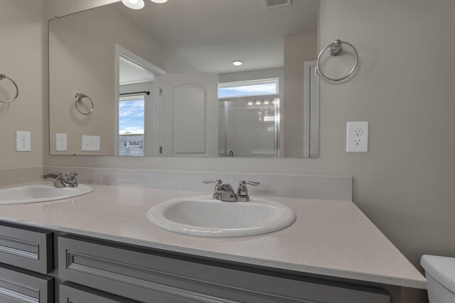 211 Whitetail Trl, Johnstown, OH 43031 - bathroom with double vanity, toilet, and a shower