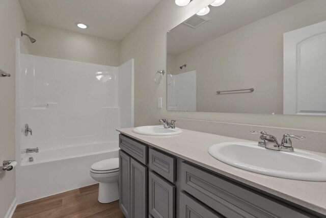 211 Whitetail Trl, Johnstown, OH 43031 - bathroom featuring toilet, bathing tub / shower combination, double vanity, and wood finished floors
