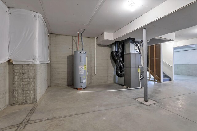 211 Whitetail Trl, Johnstown, OH 43031 - basement with water heater, heating unit, stairs, and brick wall