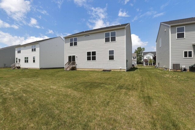 211 Whitetail Trl, Johnstown, OH 43031 - back of property featuring central AC unit, a yard, and entry steps