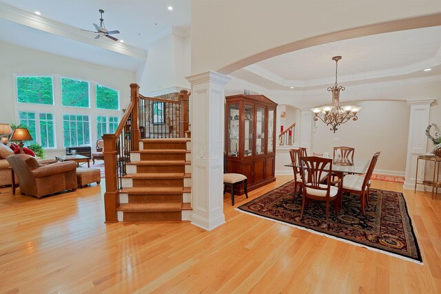 7699 Clear Creek Ct, Blacklick, OH 43004 - dining area with arched walkways, light wood-type flooring, crown molding, stairs, and a ceiling fan
