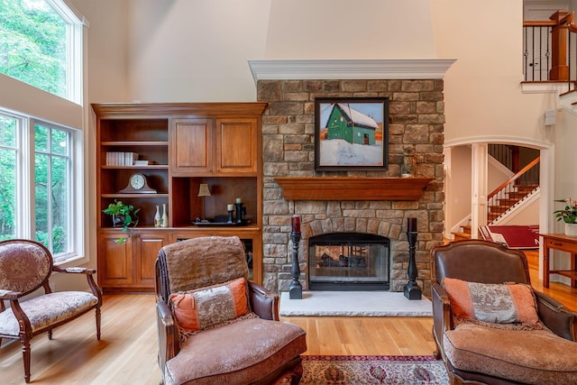 7699 Clear Creek Ct, Blacklick, OH 43004 - sitting room with light wood finished floors, stairs, a fireplace, and a high ceiling