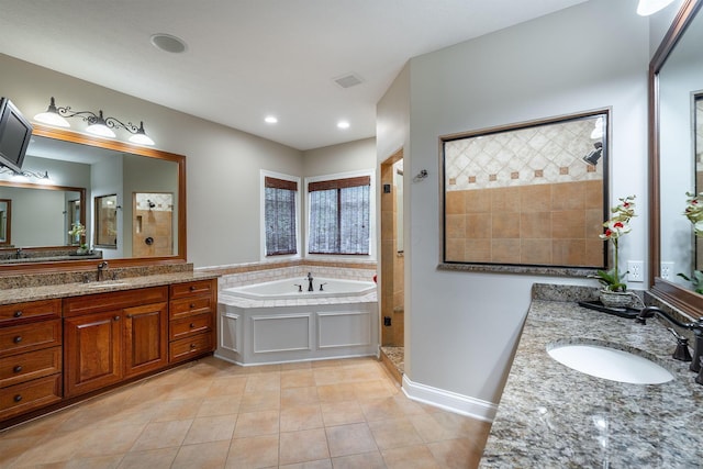 7699 Clear Creek Ct, Blacklick, OH 43004 - full bathroom featuring a bath, a stall shower, two vanities, tile patterned floors, and recessed lighting