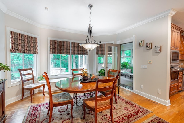 7699 Clear Creek Ct, Blacklick, OH 43004 - dining room featuring healthy amount of natural light, light wood-style floors, ornamental molding, and baseboards
