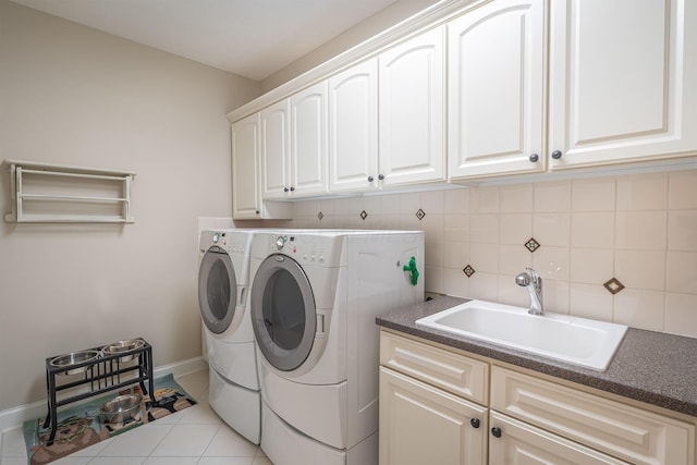 7699 Clear Creek Ct, Blacklick, OH 43004 - washroom with cabinet space, washing machine and dryer, baseboards, and light tile patterned flooring