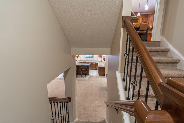 7699 Clear Creek Ct, Blacklick, OH 43004 - stairway featuring a textured ceiling and carpet