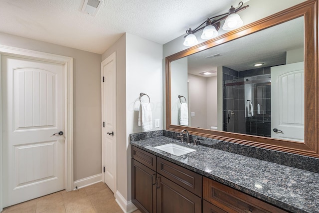 7699 Clear Creek Ct, Blacklick, OH 43004 - full bathroom featuring vanity, a shower stall, baseboards, tile patterned flooring, and a textured ceiling