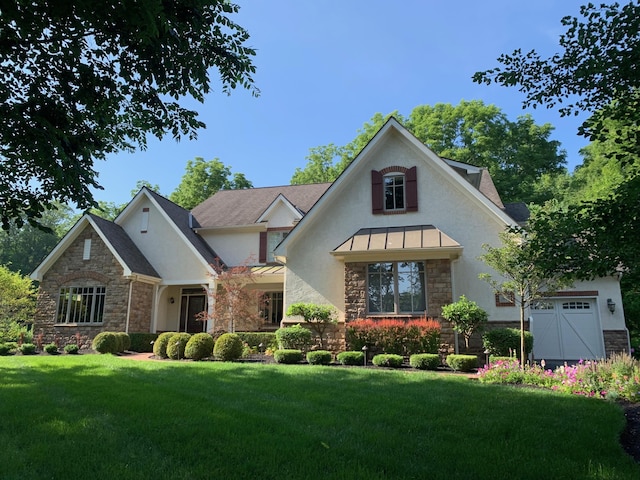 7699 Clear Creek Ct, Blacklick, OH 43004 - view of front of home featuring stone siding, stucco siding, a front yard, and a standing seam roof