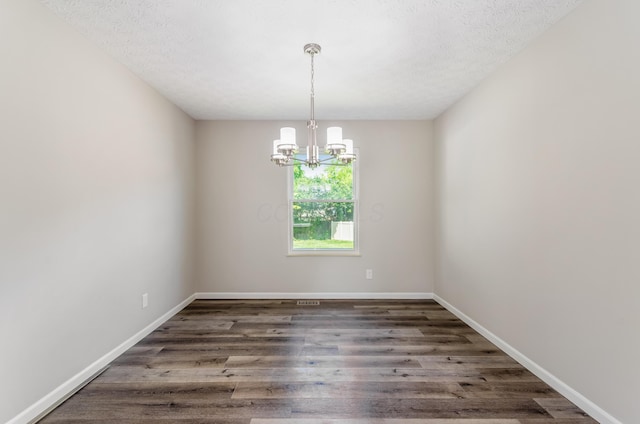 3248 Medoma Dr, Columbus, OH 43204 - empty room with a chandelier, wood finished floors, and a textured ceiling