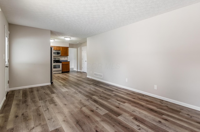 3248 Medoma Dr, Columbus, OH 43204 - unfurnished living room with wood finished floors and a textured ceiling