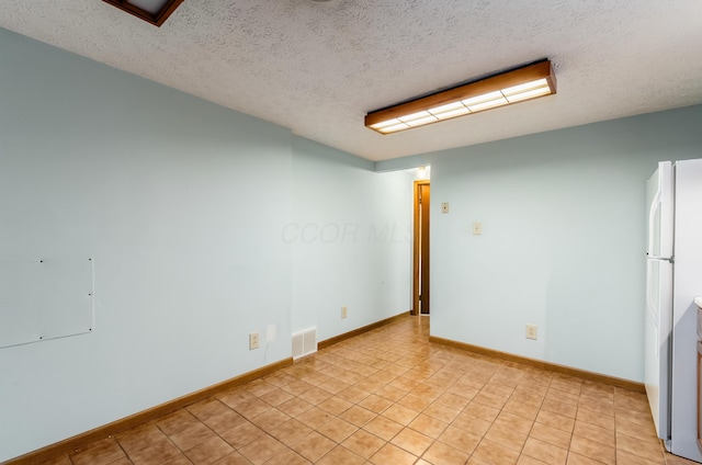 3248 Medoma Dr, Columbus, OH 43204 - unfurnished room with a textured ceiling and light tile patterned floors
