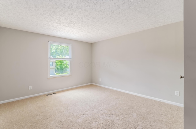 3248 Medoma Dr, Columbus, OH 43204 - carpeted empty room with baseboards and a textured ceiling