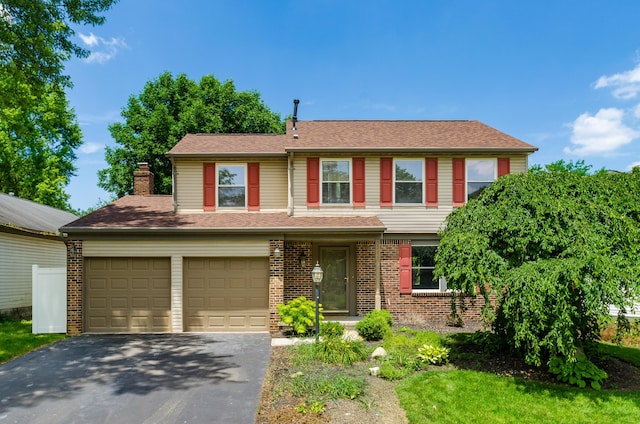 3248 Medoma Dr, Columbus, OH 43204 - view of front of home featuring driveway, brick siding, a chimney, and a shingled roof