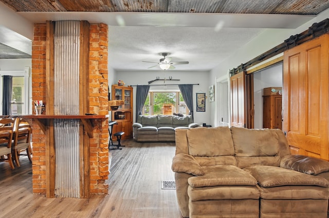 1282 Taylortown Rd, Mansfield, OH 44903 - living room with light wood-type flooring, ceiling fan, and a barn door