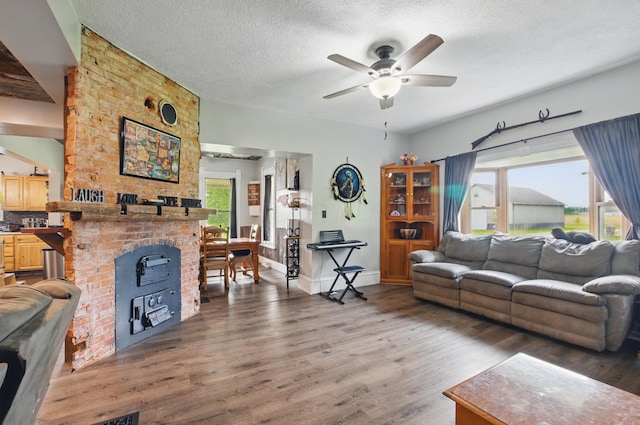 1282 Taylortown Rd, Mansfield, OH 44903 - living area with wood finished floors, a ceiling fan, a textured ceiling, a fireplace, and baseboards