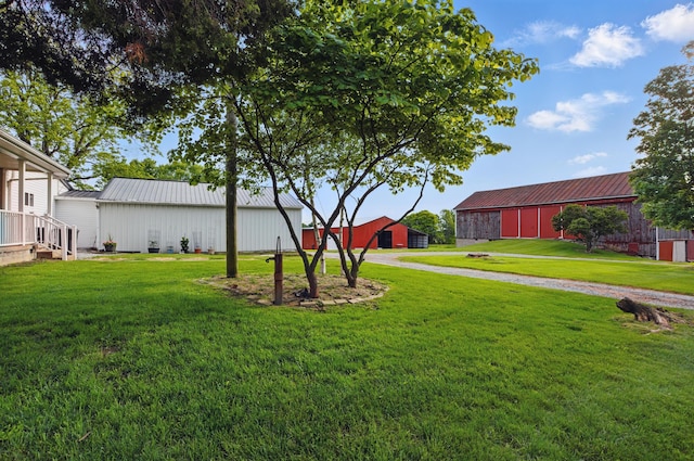 1282 Taylortown Rd, Mansfield, OH 44903 - view of grassy yard featuring an outbuilding, an outdoor structure, driveway, and a garage