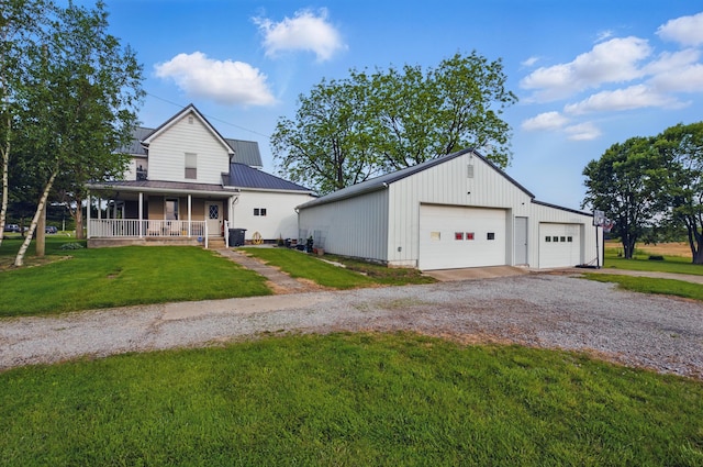 1282 Taylortown Rd, Mansfield, OH 44903 - view of front facade with a garage, a front lawn, a porch, an outdoor structure, and metal roof