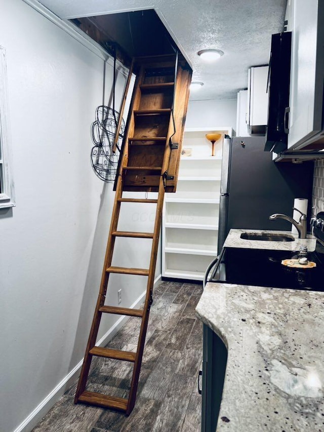 3037 La Vista Dr Unit 39, Columbus, OH 43204 - stairs featuring wood finished floors, baseboards, and a textured ceiling