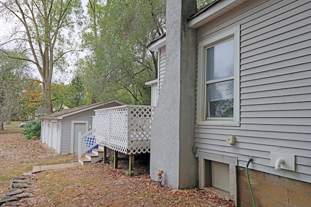 301 W Marion St, Mount Gilead, OH 43338 - view of home's exterior with an outdoor structure, a wooden deck, and a chimney