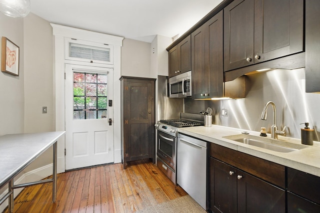 420 Stanley Ave, Columbus, OH 43206 - kitchen with appliances with stainless steel finishes, a sink, dark brown cabinets, and light wood finished floors