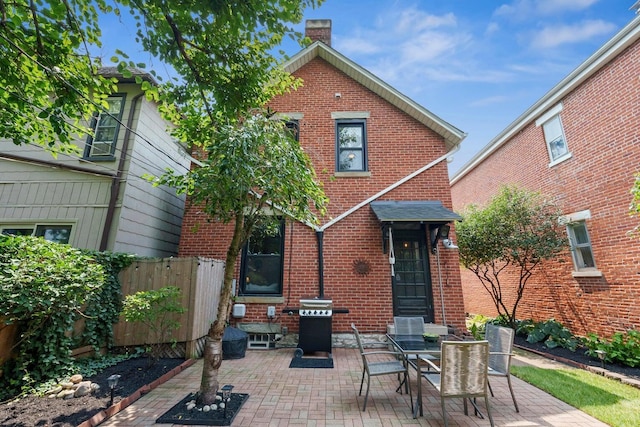 420 Stanley Ave, Columbus, OH 43206 - rear view of house featuring brick siding, a patio area, and a chimney