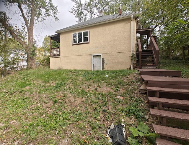 2108 Paul Dr, Columbus, OH 43211 - view of property exterior with stairway, stucco siding, and a deck
