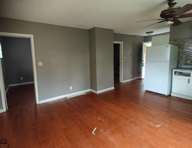 2108 Paul Dr, Columbus, OH 43211 - kitchen featuring freestanding refrigerator, ceiling fan, wood finished floors, baseboards, and white cabinets