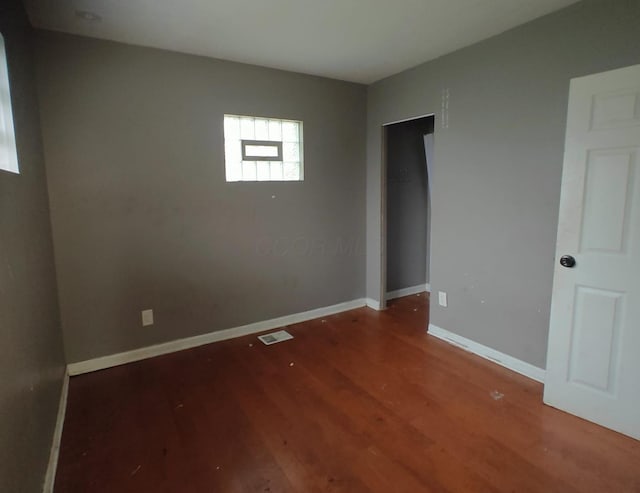 2108 Paul Dr, Columbus, OH 43211 - unfurnished bedroom featuring wood finished floors, baseboards, and a closet