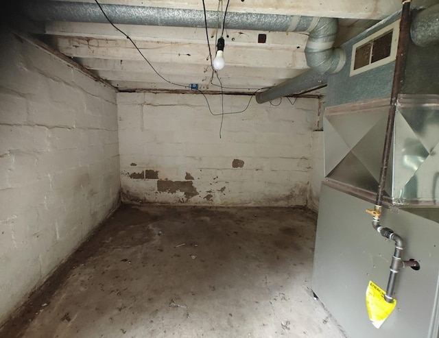 2108 Paul Dr, Columbus, OH 43211 - unfinished below grade area featuring heating unit and concrete block wall