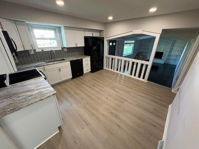 5464 Aspen Rd, Columbus, OH 43229 - kitchen with black appliances, a sink, decorative backsplash, white cabinetry, and light wood-type flooring