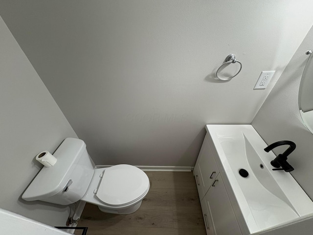 5464 Aspen Rd, Columbus, OH 43229 - half bathroom featuring vanity, baseboards, wood finished floors, and toilet