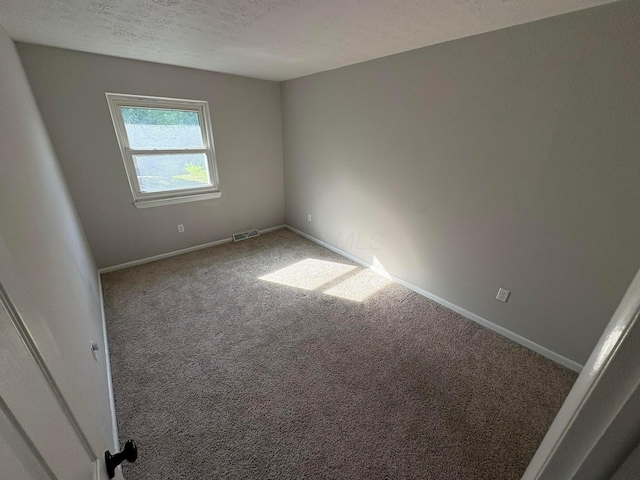 5464 Aspen Rd, Columbus, OH 43229 - unfurnished room featuring carpet flooring, baseboards, and a textured ceiling