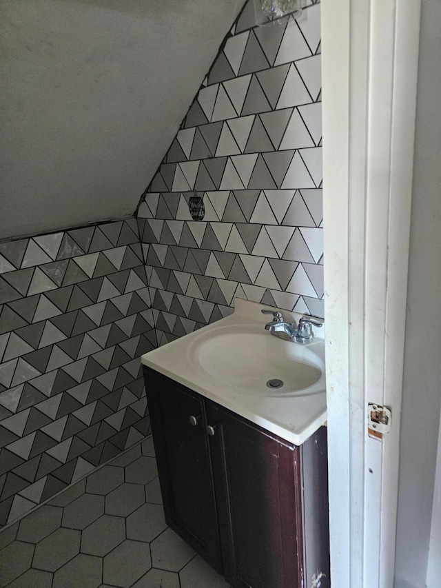 271 Carilla Ln, Columbus, OH 43228 - bathroom with vanity, tile patterned flooring, and vaulted ceiling