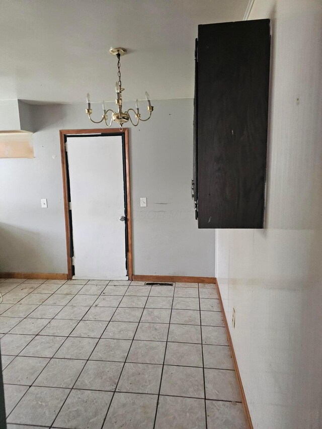 271 Carilla Ln, Columbus, OH 43228 - unfurnished room featuring a chandelier, light tile patterned floors, and baseboards