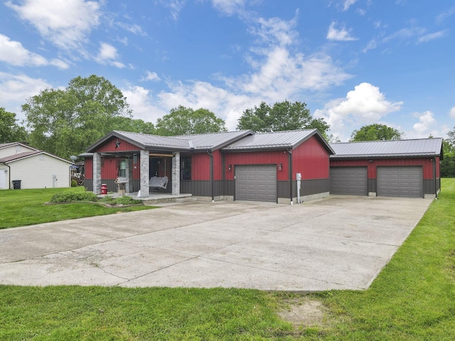 14609 Hock Hocking Rd, Logan, OH 43138 - view of front facade featuring covered porch, metal roof, a front lawn, driveway, and an attached garage