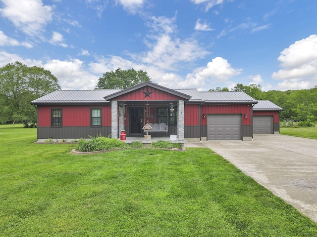 14609 Hock Hocking Rd, Logan, OH 43138 - view of front of house with concrete driveway, a front yard, a garage, and metal roof