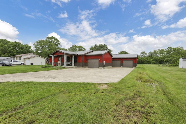 14609 Hock Hocking Rd, Logan, OH 43138 - view of front facade featuring a front yard, concrete driveway, a garage, and metal roof