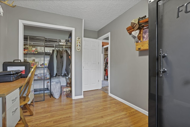 14609 Hock Hocking Rd, Logan, OH 43138 - bedroom featuring light wood-style floors, baseboards, a desk, and a textured ceiling