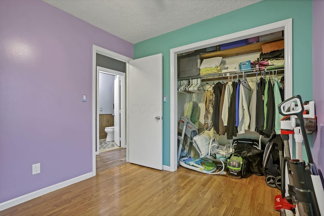 14609 Hock Hocking Rd, Logan, OH 43138 - bedroom featuring wood finished floors, baseboards, a closet, and a textured ceiling