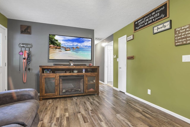 14609 Hock Hocking Rd, Logan, OH 43138 - living area featuring wood finished floors, baseboards, and a textured ceiling