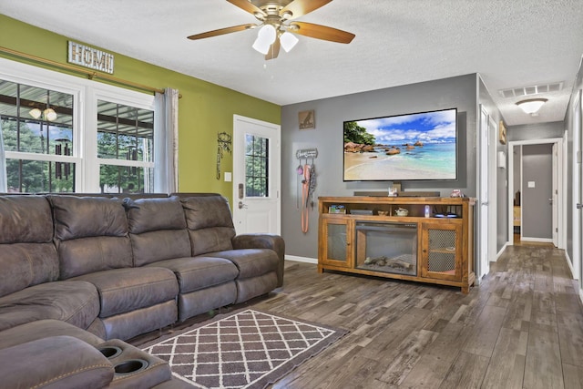 14609 Hock Hocking Rd, Logan, OH 43138 - living area with wood finished floors, ceiling fan, a textured ceiling, and baseboards