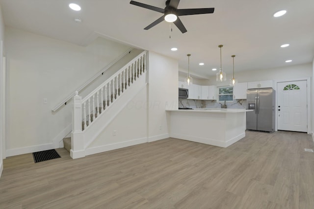 1676 Parsons Ave, Columbus, OH 43207 - kitchen featuring stainless steel fridge with ice dispenser, light countertops, recessed lighting, light wood finished floors, and white cabinets