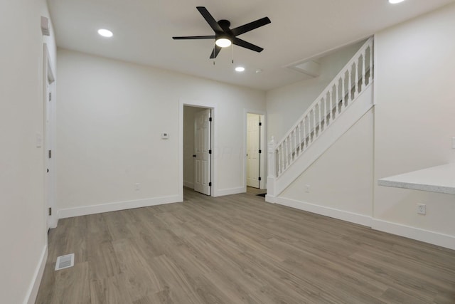1676 Parsons Ave, Columbus, OH 43207 - unfurnished living room featuring wood finished floors, recessed lighting, ceiling fan, baseboards, and stairs