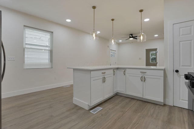 1676 Parsons Ave, Columbus, OH 43207 - kitchen with a ceiling fan, light countertops, light wood-style flooring, healthy amount of natural light, and recessed lighting
